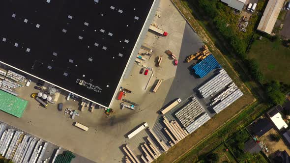 Aerial view of goods warehouse. Logistics delivery center in industrial city zone from above. Aerial