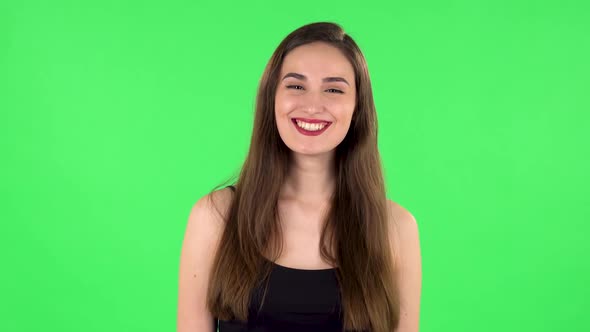 Portrait of Cheery Female Bursting with Laughter Being in Positive Over Green Screen