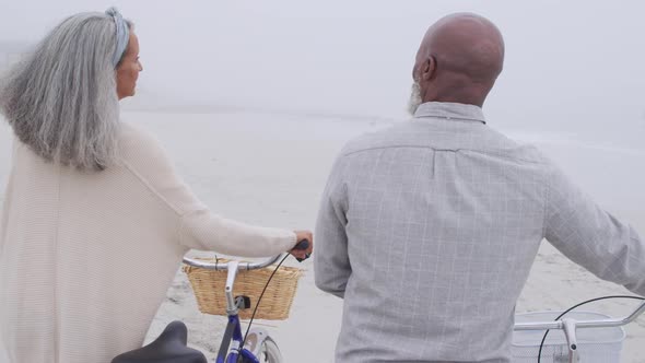 Mature couple enjoying time outside by the sea