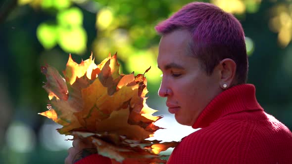 Portrait of Young Gay at Autumn Sunny Day, Man Is Viewing Bouquet From Dry Yellow Leaves