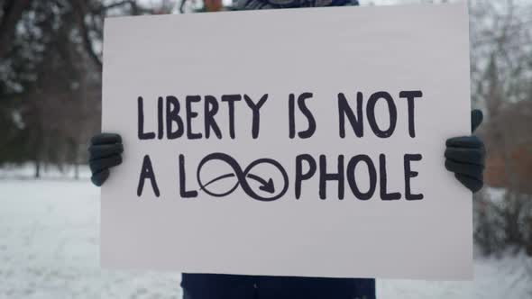 An Activist is Revolting with the Big White Banner Liberty is Not A Loophole