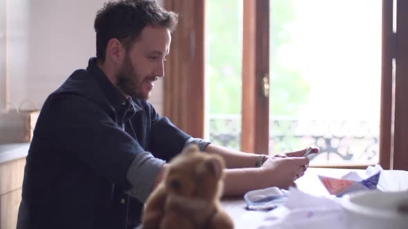 Man entertaining himself with multimedia smartphone at home