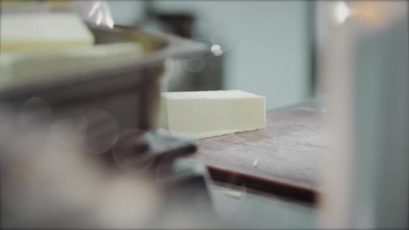 the Chef's Hands in Blue Gloves Cut a Piece of Butter with a Knife Catering