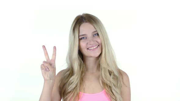 Portrait Of Beautiful Woman Showing Victory Sign, White Background