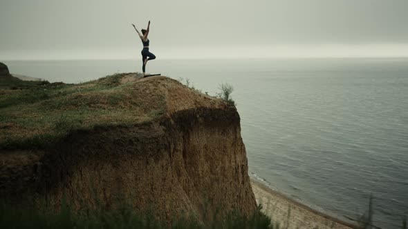 Girl Doing Yoga Tree Pose on Beach Hilltop