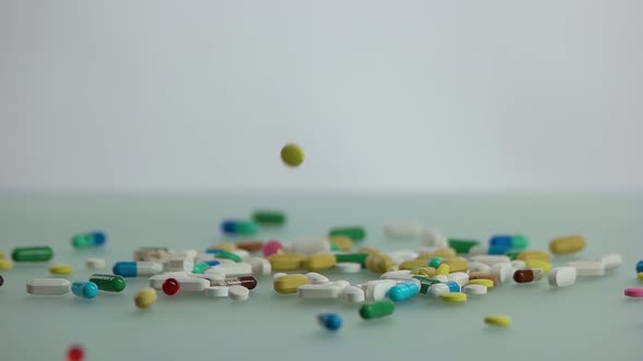 Colorful Medical Capsules Falling on the Table