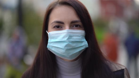 Portrait of a Mixed Race Woman in the City Streets During the Day, Wearing a Face Mask