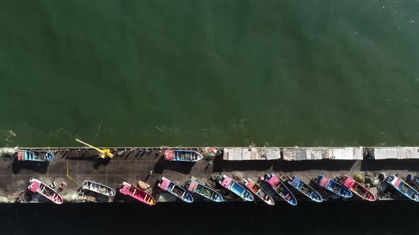 Fishermen's Boats On The Port Of Playa Maguillines In Constitucion, Maule, Chile. Aerial Tracking Sh