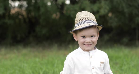 Portrait of a Beautiful Little Boy Laughing and Having Fun in the Park