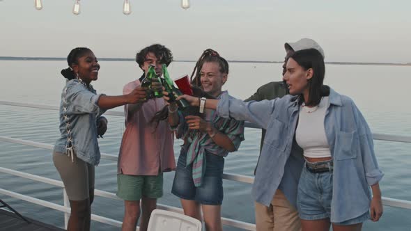 Diverse Friends Drinking Beer by Lake