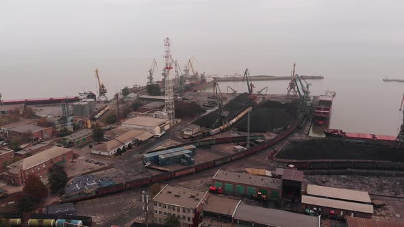 Shooting From a Drone of a Seaport with Cranes and Tankers for Transporting Coal and Oil