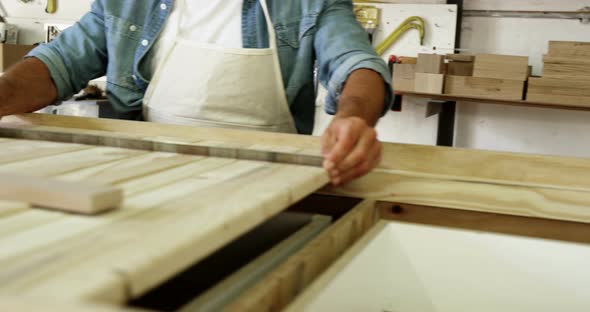 Carpenter working on his craft and smiling for camera