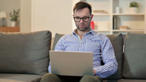 Professional Young Man Using Laptop at Home 