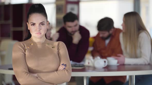 Close-up of Gorgeous Caucasian Woman Gesturing No By Shaking Head As Her Groupmates Working on