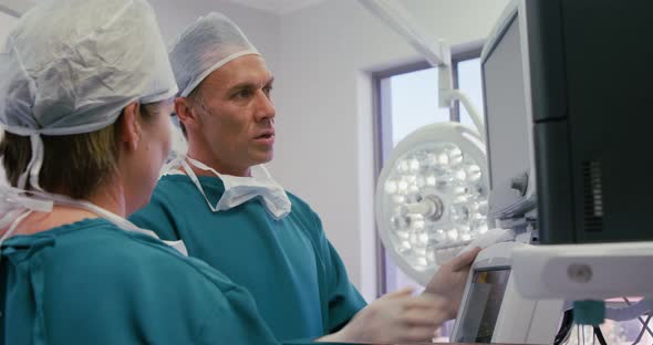 Male surgeon interacting with a colleague in operation room