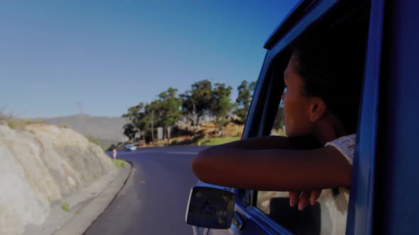 Young woman on a road trip in pick-up truck