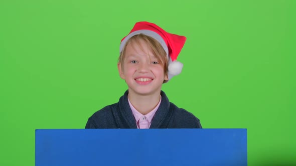Child Boy Appeared From Behind a Blue Poster To Look at Him Shakes Her Head. Green Screen