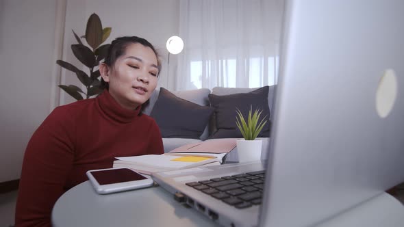 Businesswoman on redshirt using the laptop for meeting online and work from home