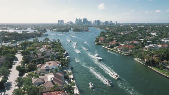 Boats Cruising At New River In Fort Lauderdale With Florida Skyline In USA. - aerial