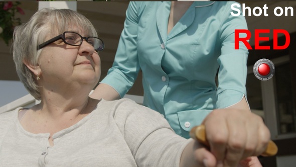 Caretaker Helping Senior To Walk