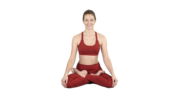 Young smiling woman practicing yoga doing Padmasana exercise,