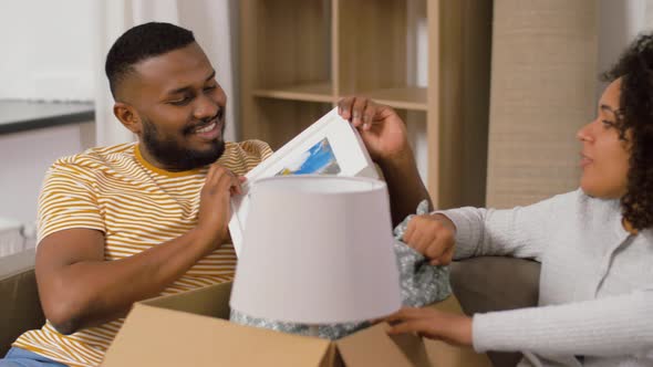 Happy Couple with Boxes Moving To New Home