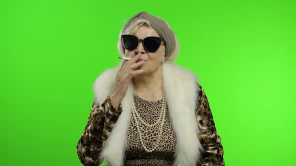 Elderly Stylish Trendy Grandmother. Caucasian Woman Smoke Cigarette. Chroma Key