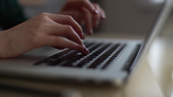 Closeup of Hands of Unrecognizable Woman Typing on Laptop Keyboard on Background of Window