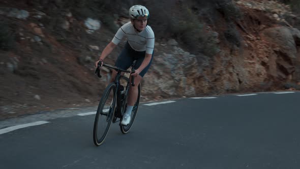 Young Professional Female Cyclist on the Road