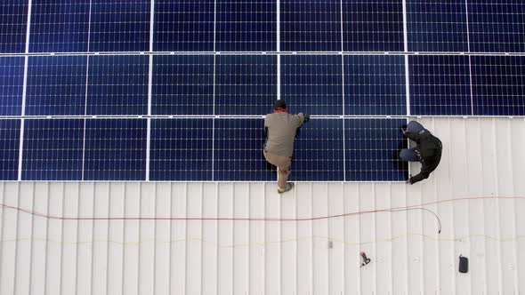 Solar Technician Installing Solar Panels on House Roof