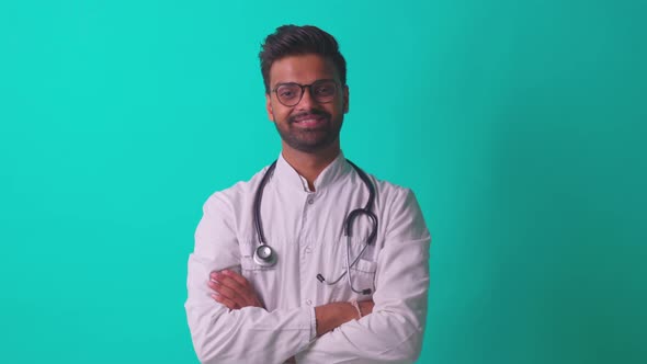 Pakistanian Doctor in White Coat with Stethoscope Feeling Confident Mock Up Over Blue Studio