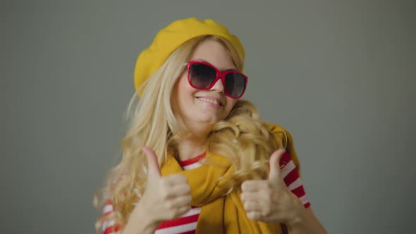 Beautiful Caucasian Woman with Sunglasses Having Fun Smiling and Dancing in Studio