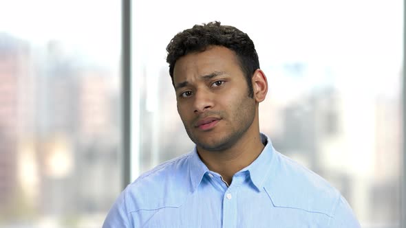 Close Up Young Disappointed Man on Blurred Background