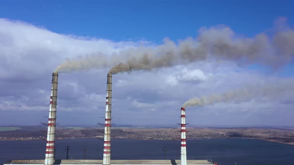 Aerial View of Old Thermoelectric Plant with Big Chimneys in a Rural Landscape Near the Reservoir