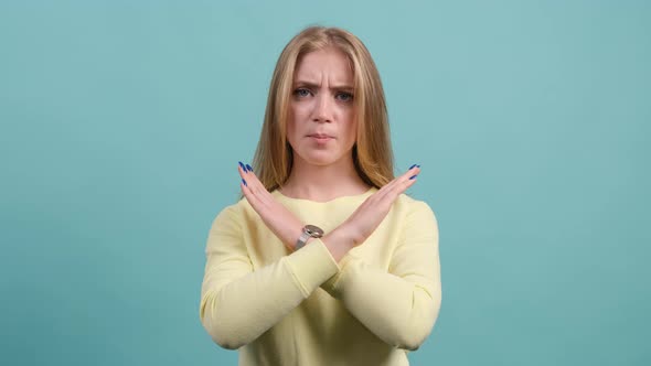 Close Up of Young Woman Making Stop Gesture Crossing Her Hands