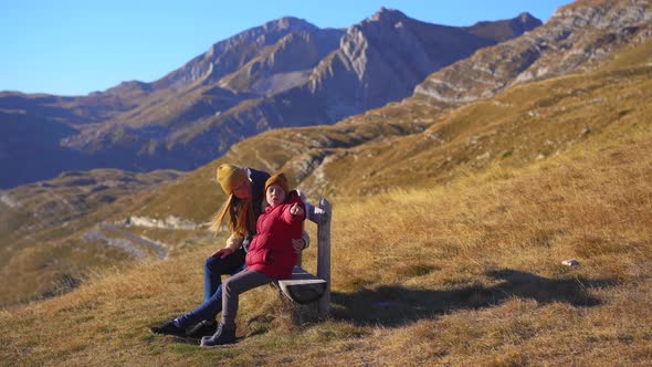 Family of Tourists Visits the Sedlo Pass Bobov Kuk in the Mountains of the Northern Montenegro