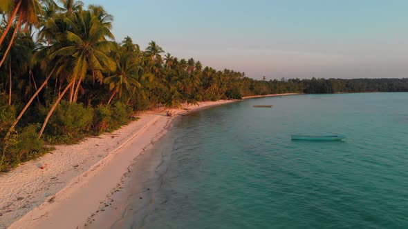 Aerial: uncontaminated white sand beach sunset at Kei Islands Maluku Indonesia