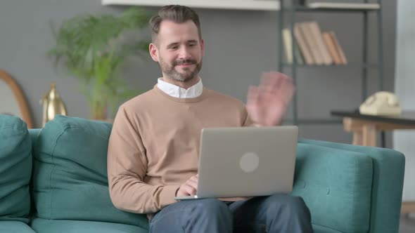 Man Doing Video Call on Laptop on Sofa