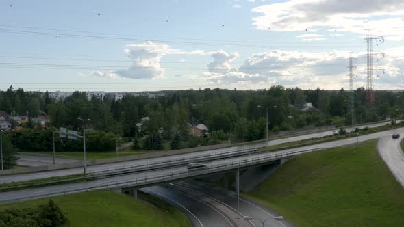 Aerial pan out of cars driving on a motorway bridge in Finland near Helsinki.