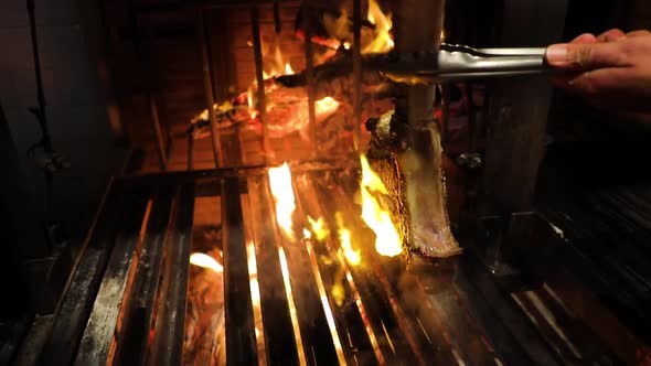 Perfect Tbone Steak Roasted on a Grill Turned on the Other Side Cooking