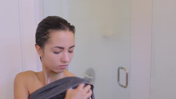 Attractive woman drying off aster taking her morning shower.