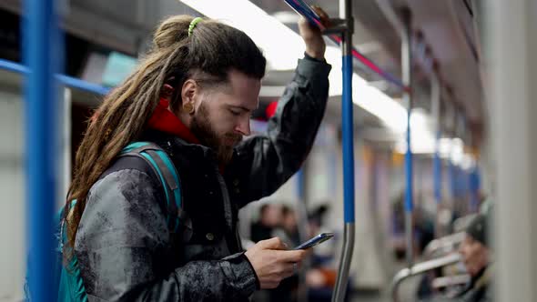 Passengers in Metro Train Daily Trip in City and Outskirt Portrait of Handsome Man with Smartphone