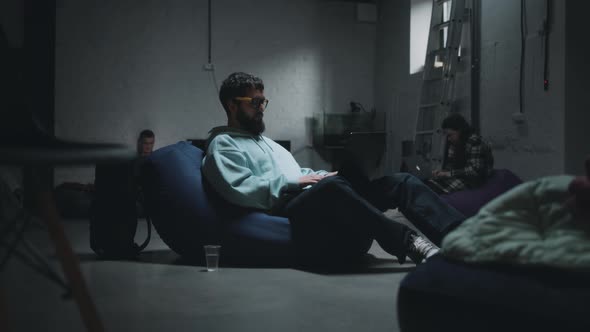 Man Using Laptop in a Bomb Shelter