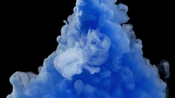 Close-up of Blue Ink Clouds Spread in Water, Small Air Bubbles and Colored Smoke Spreading