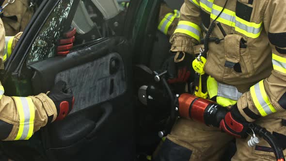 Firefighters Cutting Car Doors To Rescue Viction of the Car Crash Accident