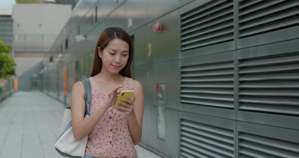 Woman use of mobile phone in city