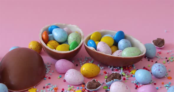 Happy Easter overhead with Easter eggs and decorations on a Pink Background