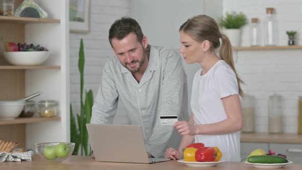 Woman and Man Making Online Payment on Laptop