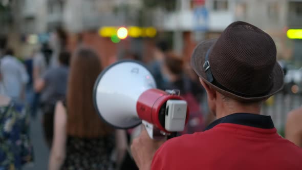 Speaking with Bullhorns Protesters Marching on City Streets in Peaceful Picket