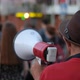 Speaking with Bullhorns Protesters Marching on City Streets in Peaceful Picket - VideoHive Item for Sale